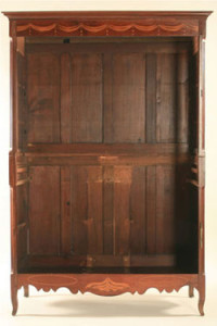 Fig. 7 Front view of Louisiana Creole armoire (ca. 1800-1830), probably New Orleans, 76 1/2 x 49 1/2 x 18 1/2 in., cherry (primary wood), poplar and cypress (secondary woods) with light wood inlays; original brass fische hinges (doors and cornice dismantled). Private collection. Click image for slideshow of details.