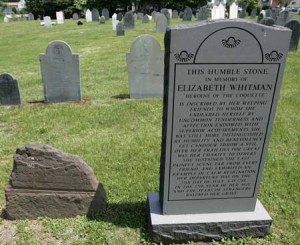 Elizabeth Whitman's headstone, on the left, damaged by relic seekers, as it has appeared since the late nineteenth century. The new stone, at the right, was installed by the Peabody Historical Commission and Peabody Institute Library in 2004 and mimics the design of Eliza Wharton's headstone in Hannah Webster Foster's The Coquette. Photo courtesy of the Salem News, Salem, Massachusetts. [The photo was used in an article on 24 July 2007]