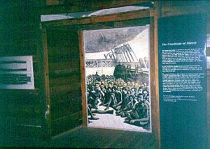 Fig. 9. Installation simulating the hold of a slave ship at Cape Coast Castle Museum. Influence from Western museum exhibition designers is seen in the use of black-and-white illustrations of the slave ship icon (left) and captives on the deck of a captured slave ship (from a mid-nineteenth-century engraving after a daguerreotype published in Harper's Weekly).